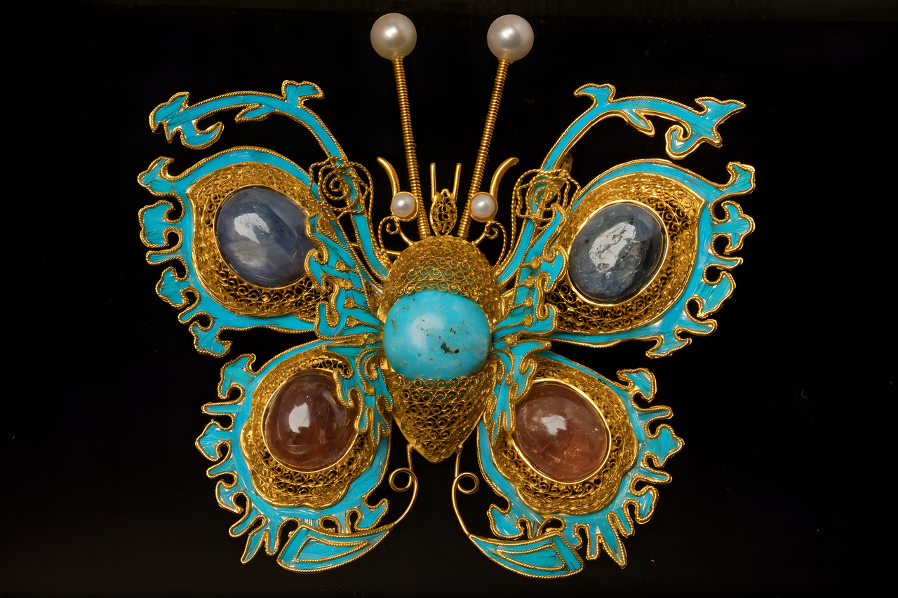 Butterfly-shaped brooch with gemstones on a black background