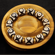 Himalayan agate Dzi bead bracelet with symbolic markings representing wisdom, unity, and good fortuneWhisper
