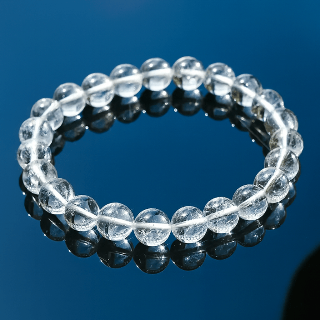 Himalayan clear quartz bracelet on dark reflective surface, high transparency with natural inclusions