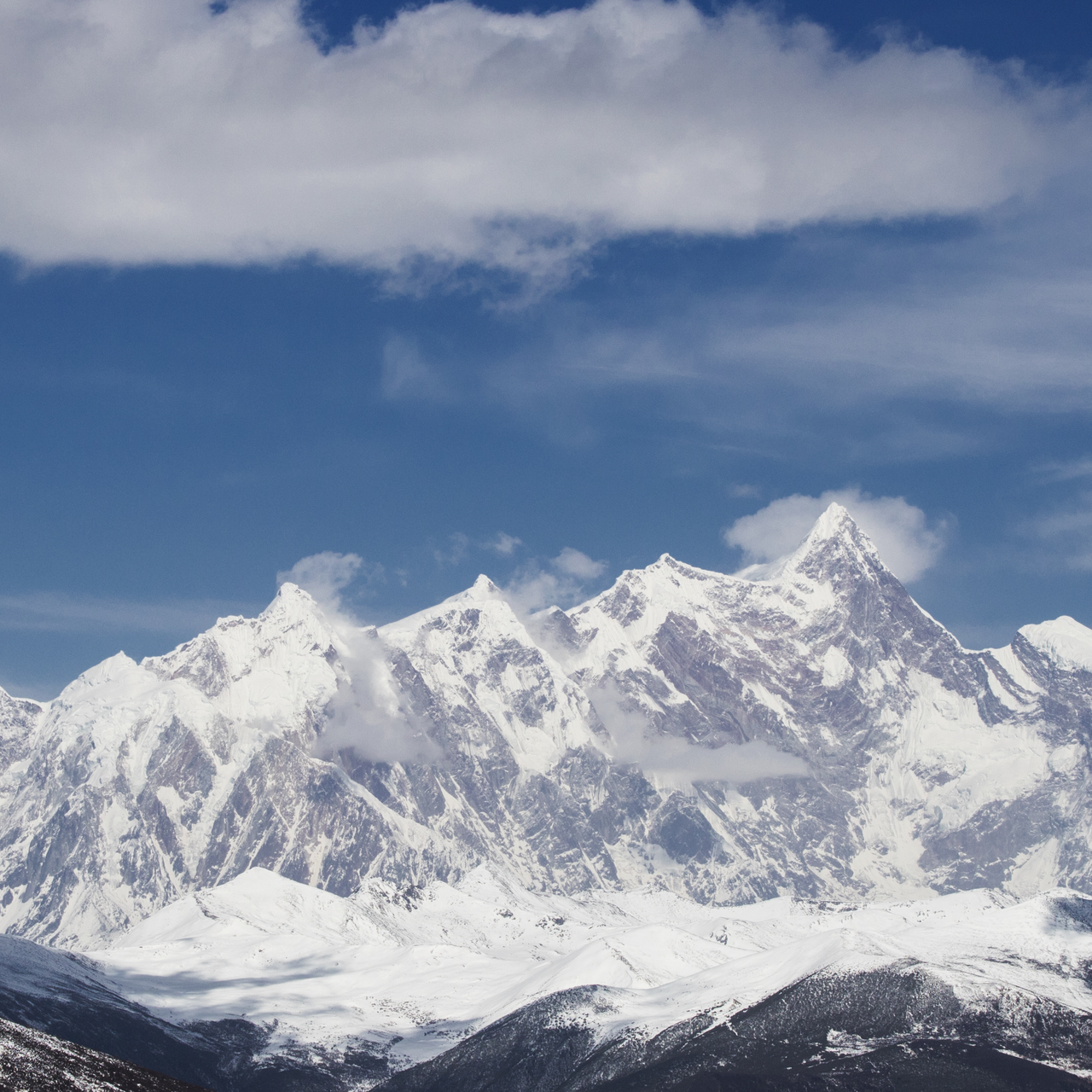 Mount Namcha Barwa summit partially veiled in clouds in southeastern Tibet