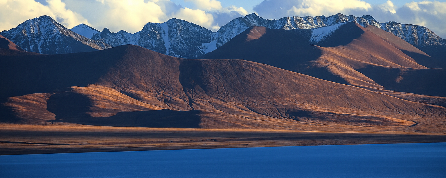 Namtso Lake in Tibet with turquoise waters and snow-covered Himalayan mountains
