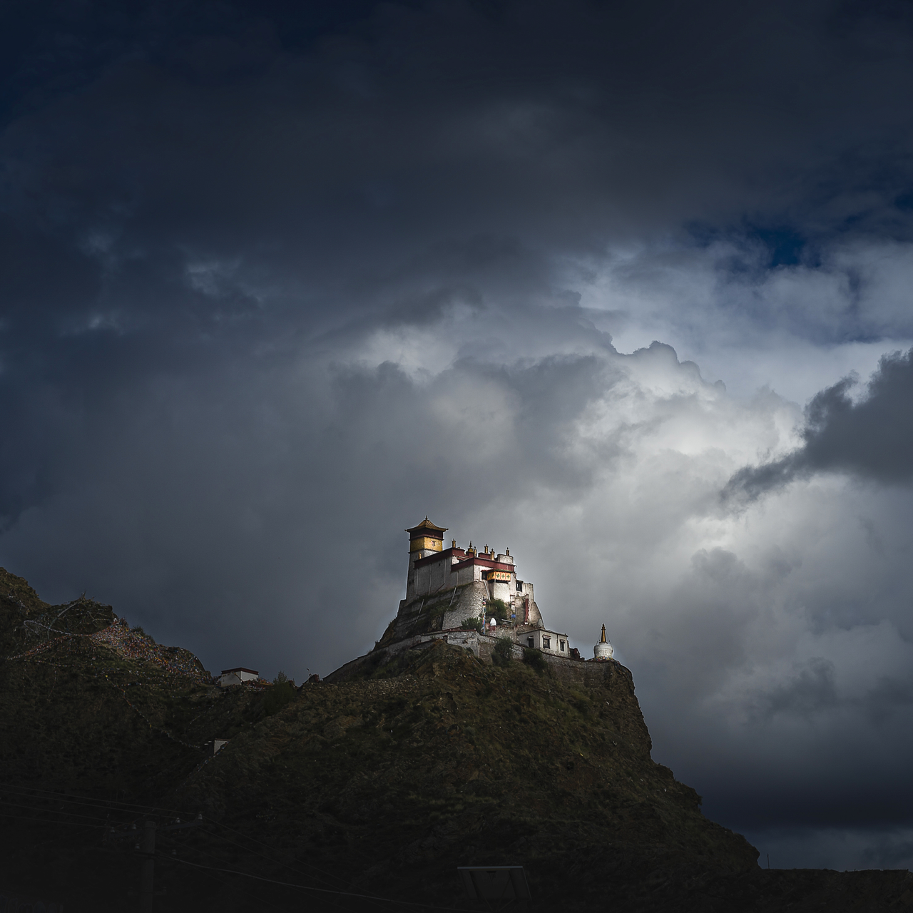 Ridge-top Yumbu Lhakhang palace in southern Tibet beneath dark clouds