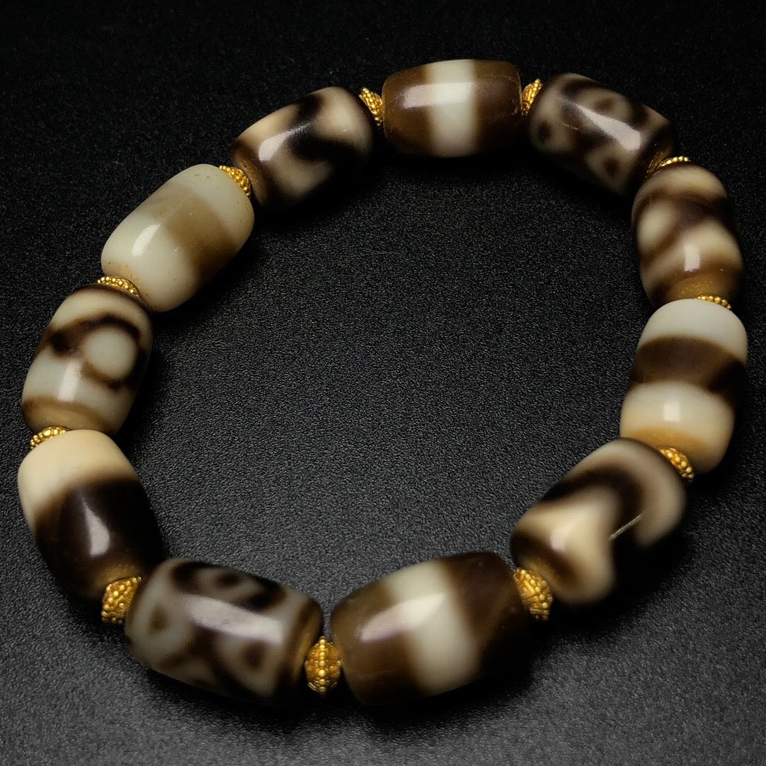 Sacred eye Dzi bead bracelet worn as spiritual jewelry for harmony, success, and energetic alignment