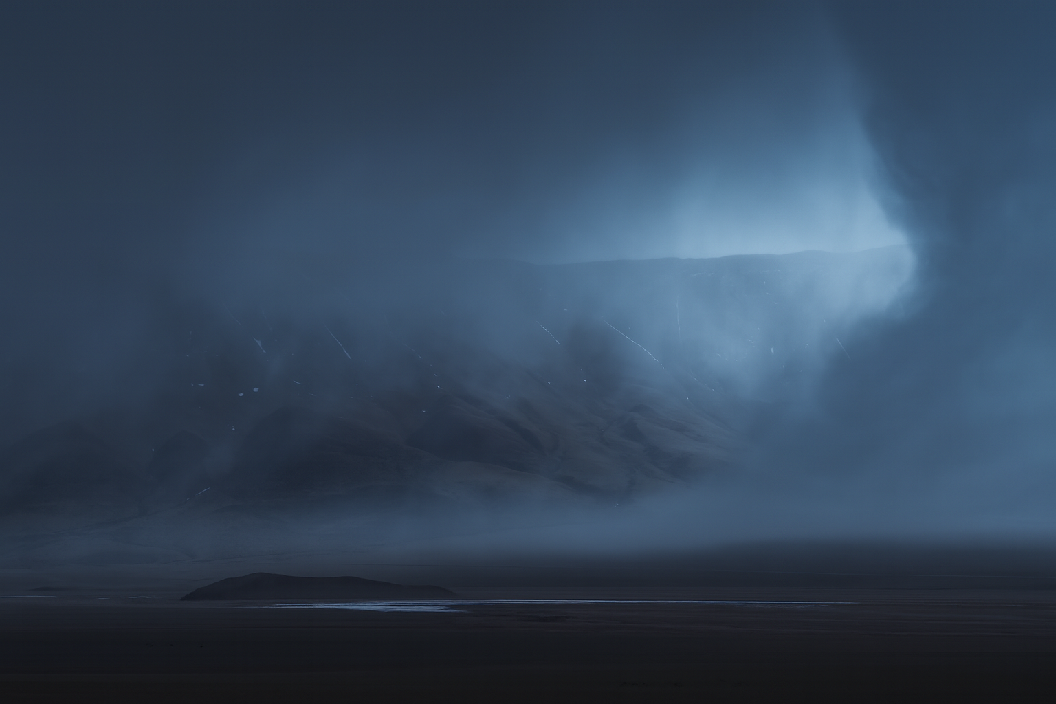 Snow-dusted mountains rising above the Changtang Plateau